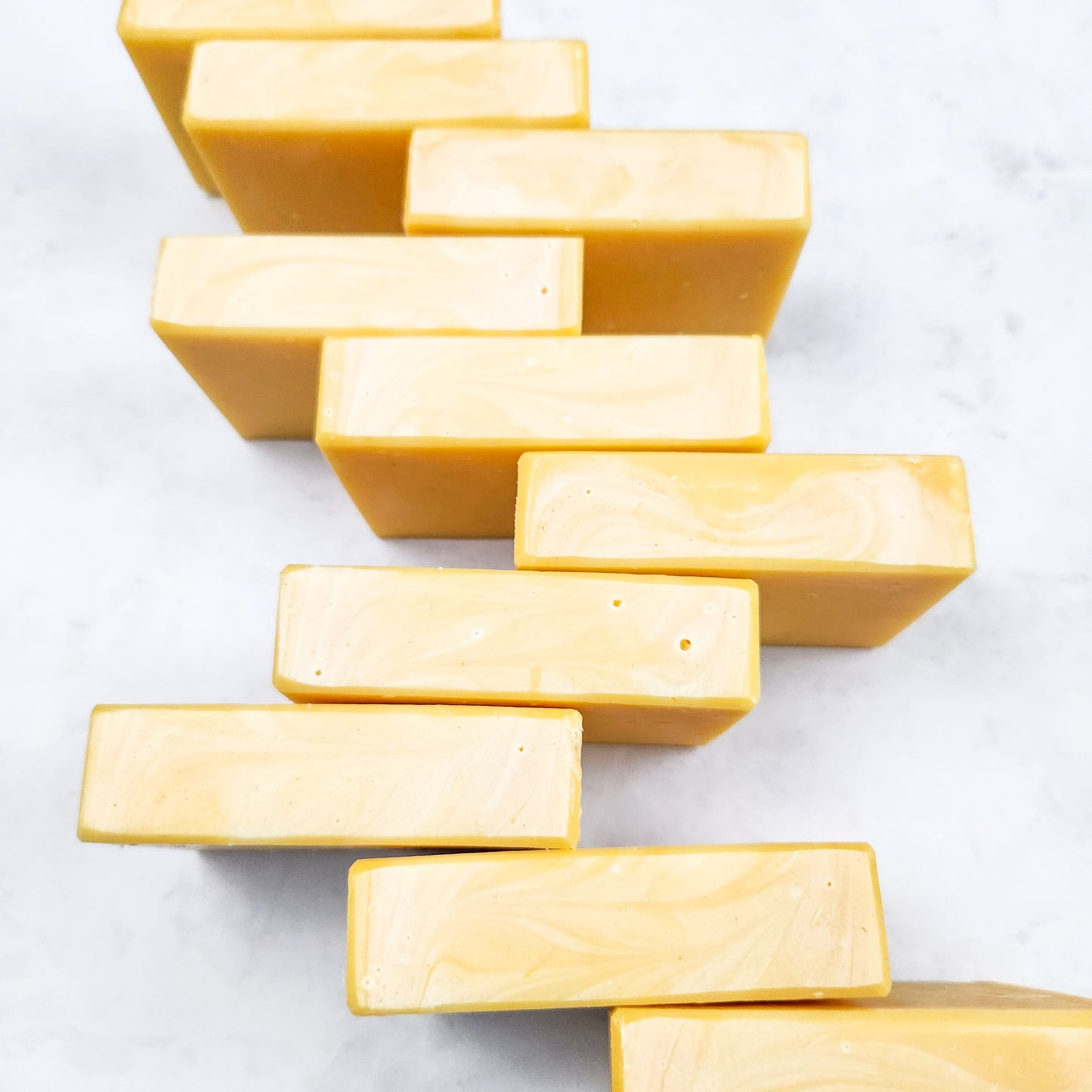 A closeup of the tops of several bars of Lemongrass soap