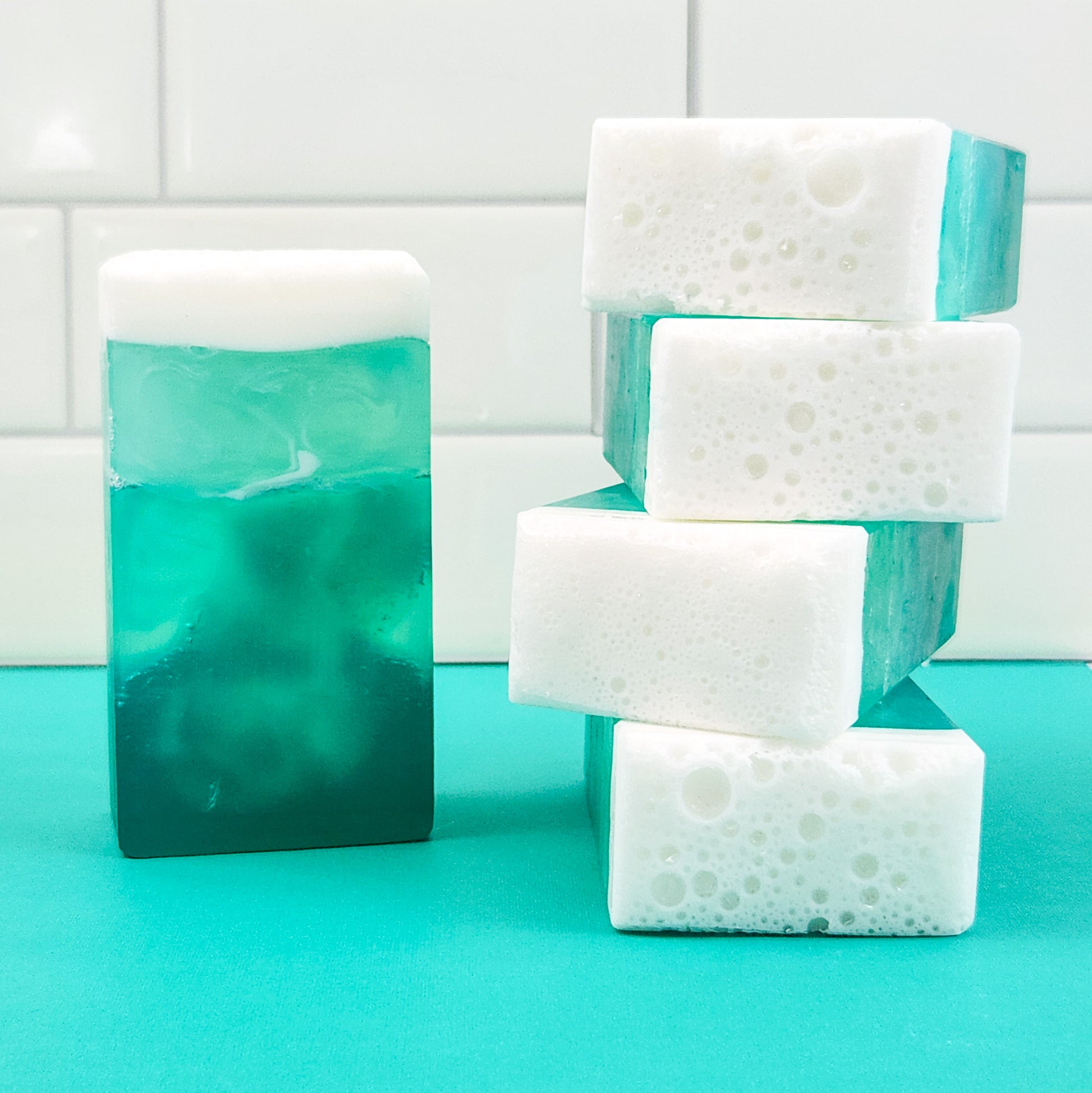 bars of soap in a blue ombre design, with a frothy white top.