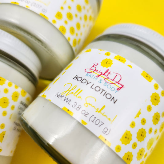 Closeup of jars of Hello Sunshine lotion on a yellow background