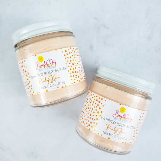 two Peachy Keen Body Butter jars on a tile background