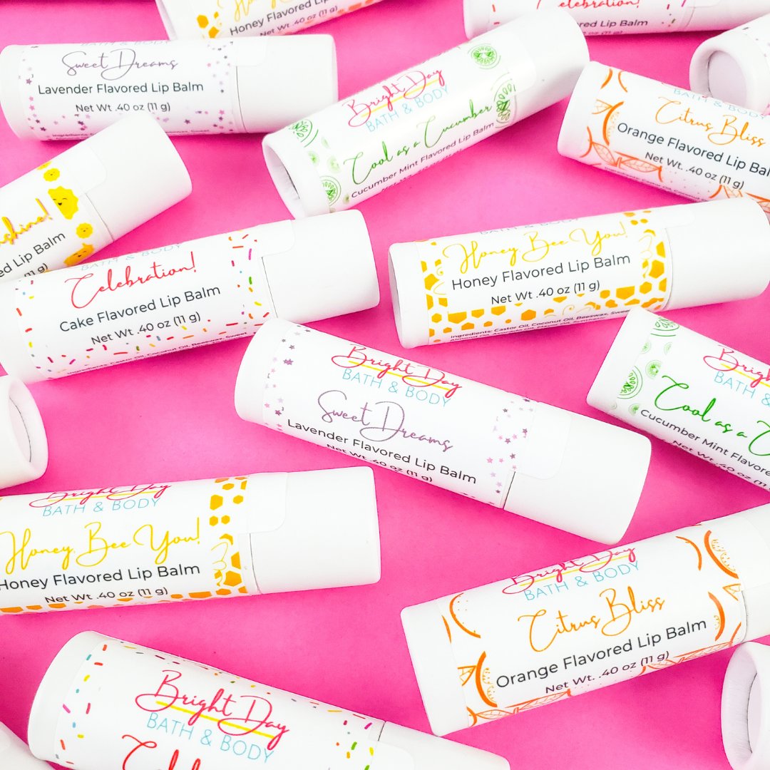 six lip balms on a marble background