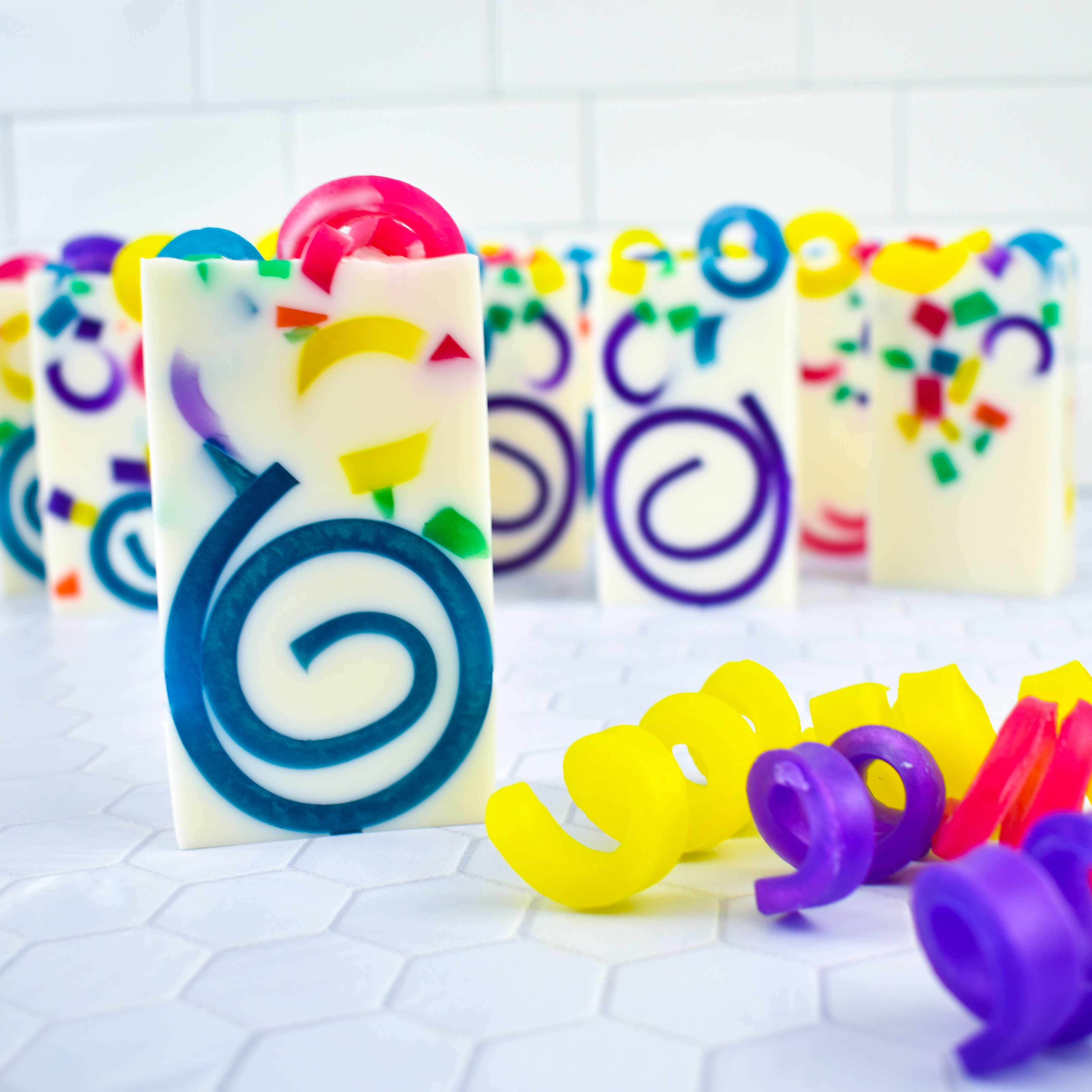 White soaps with a colorful swirl and confetti design