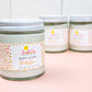 Three jars of Peachy Keen Body Lotion on a pink and white background.