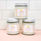Three jars of Peachy Keen Body Lotion stacked like a pyramid on a pink and white background.