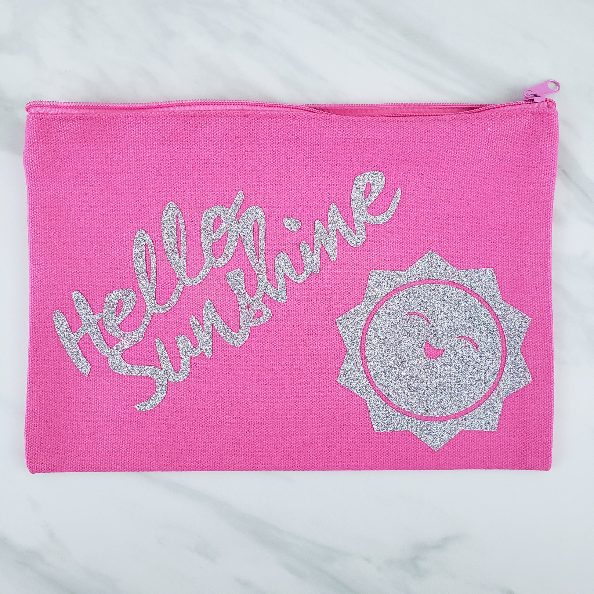 Pink cosmetic bag with "hello sunshine" in silver letters