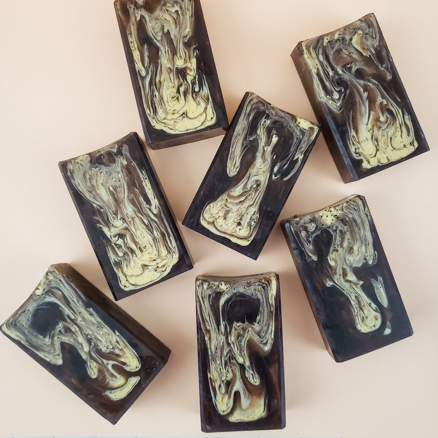 brown bar soaps with light brown swirls on a tan background