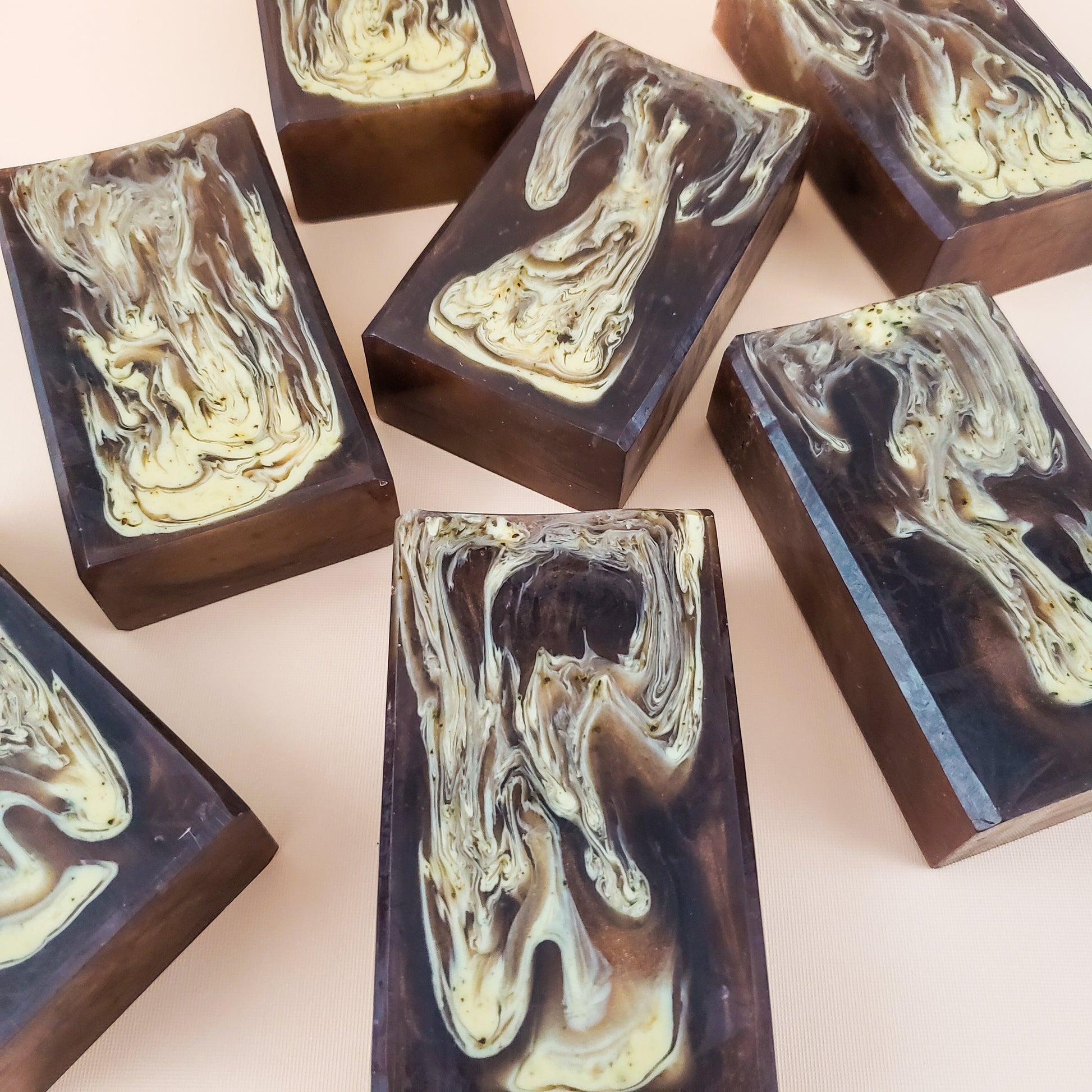 brown bar soaps with light brown swirls on a tan background