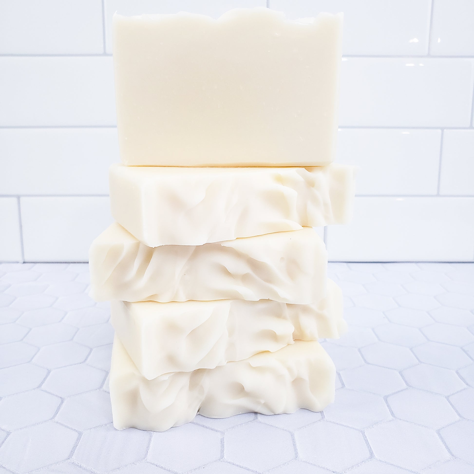 a stack of five white soap bars