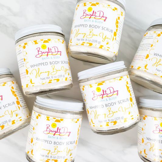 Honey Bee You Body Scrub Jars on a tile background