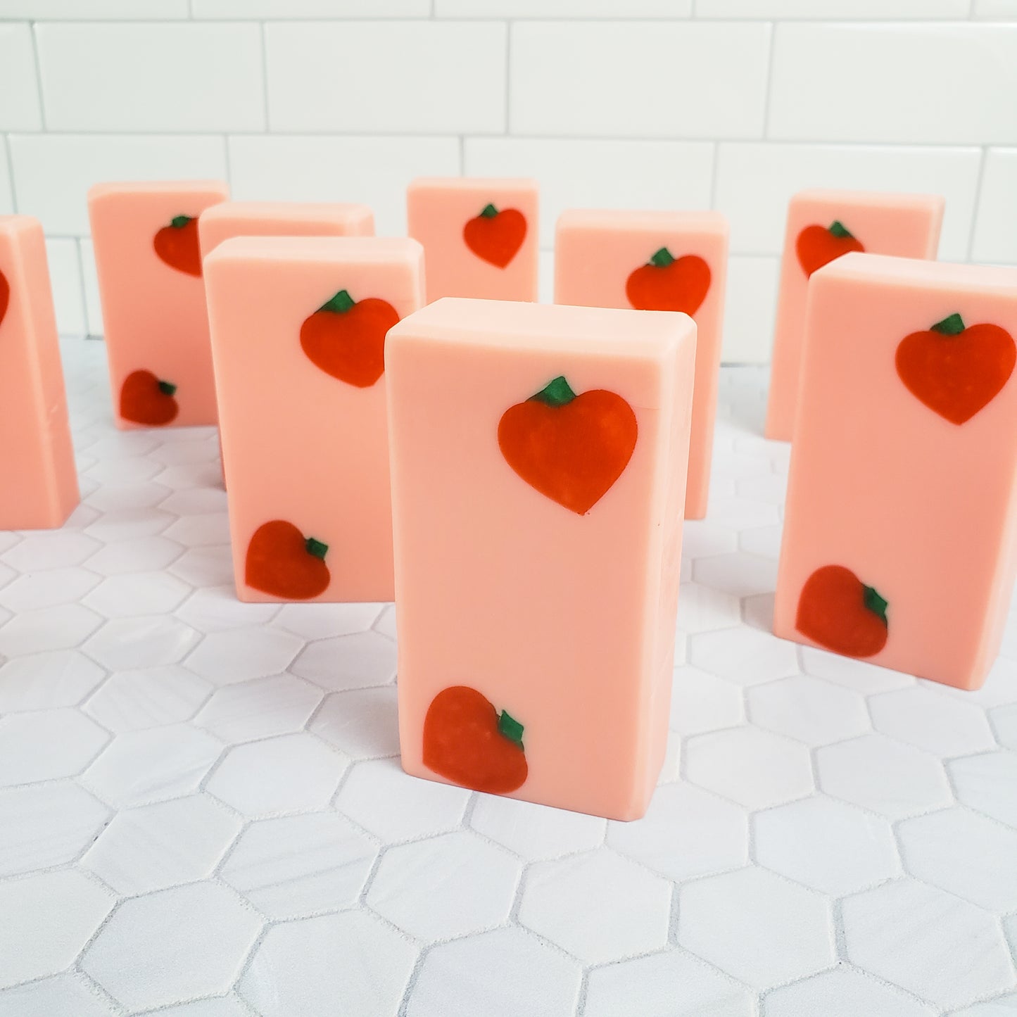 Peach colored rectangle soaps with dark peach shapes in two diagonal corners of each bar