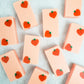 Peach colored rectangle soaps with dark peach shapes in two diagonal corners of each bar