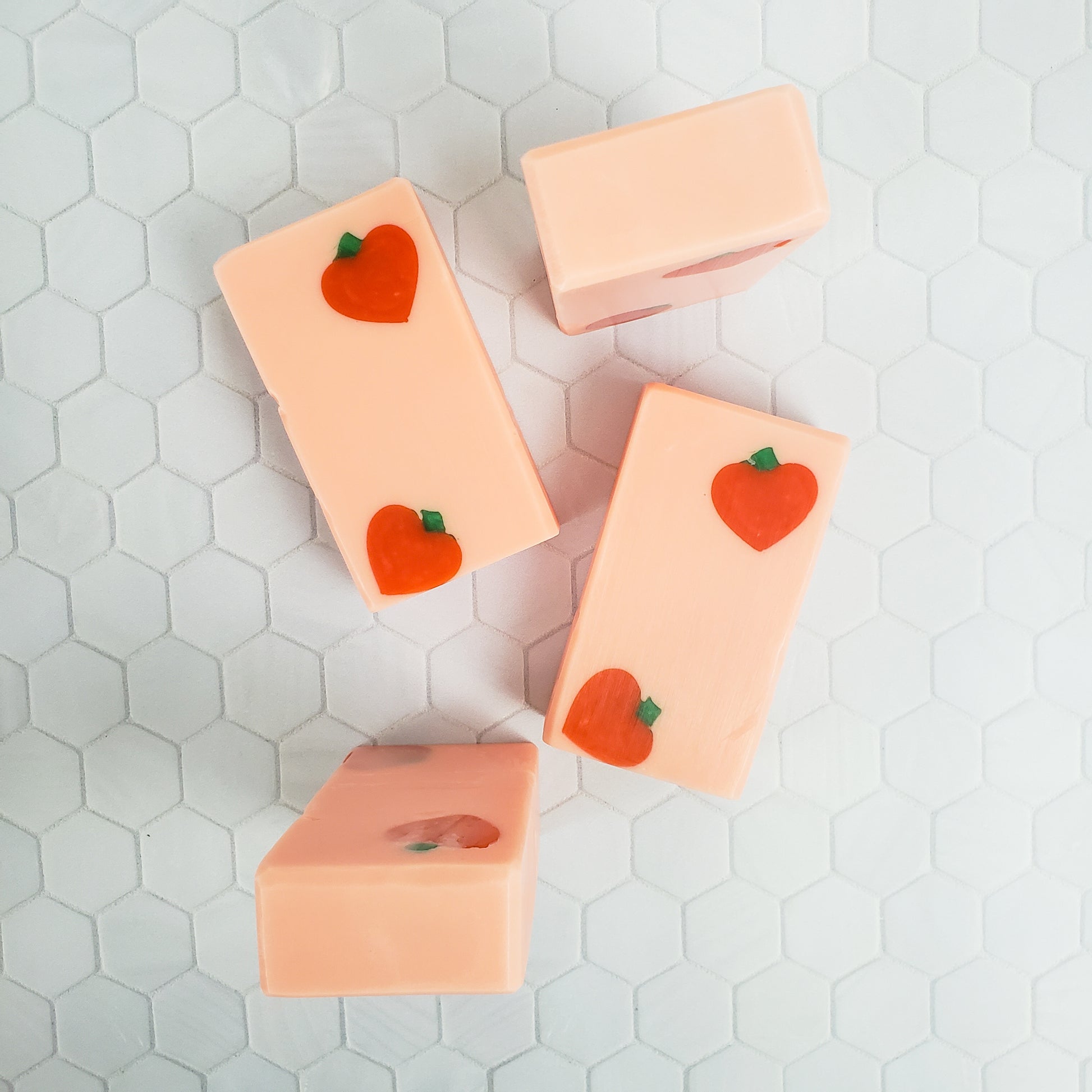 Peach colored rectangle soaps with dark peach shapes in two diagonal corners of each bar