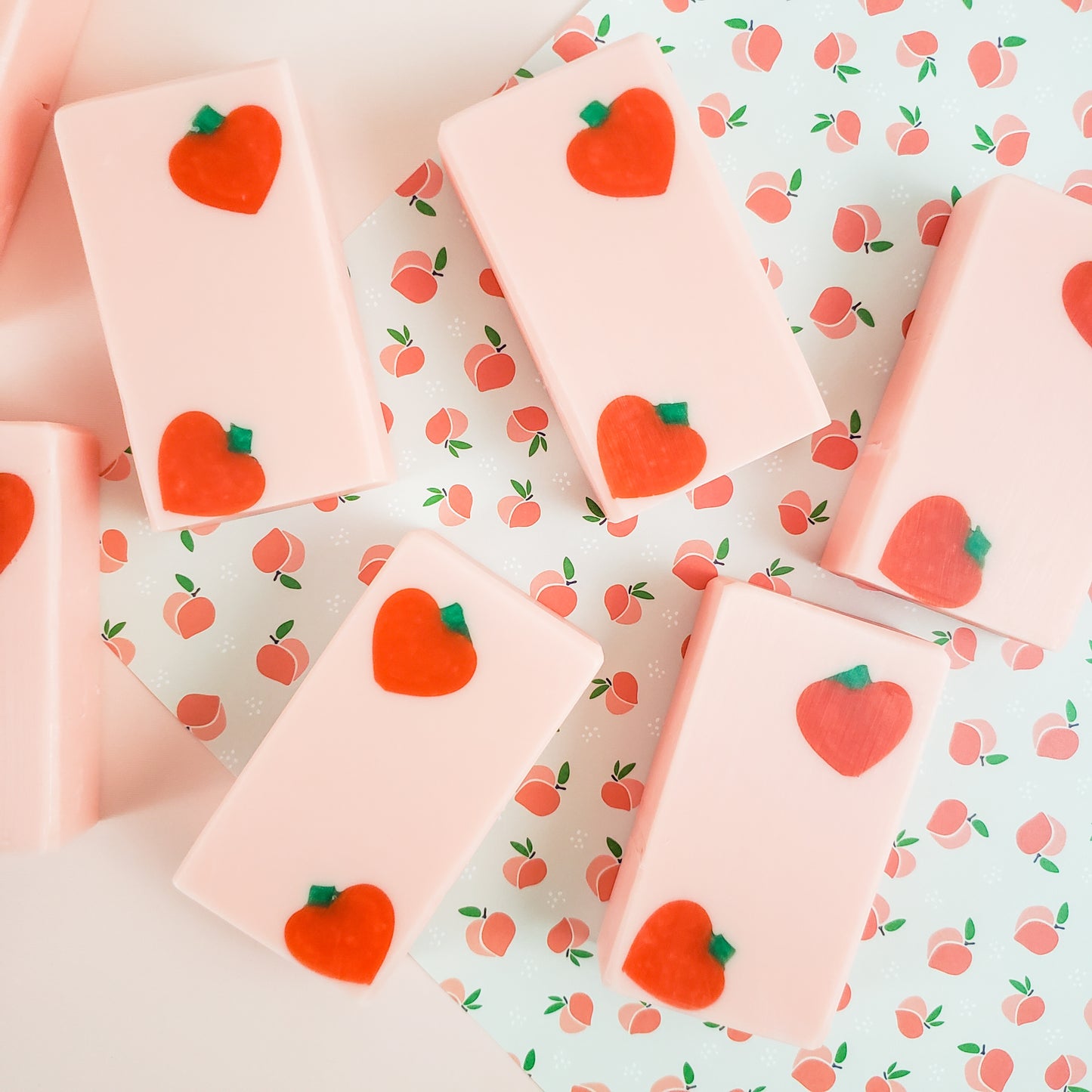 Peach colored rectangle soaps with dark peach shapes in two diagonal corners of each bar