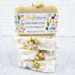 a stack of cream colored soap bars with jasmine flowers on top