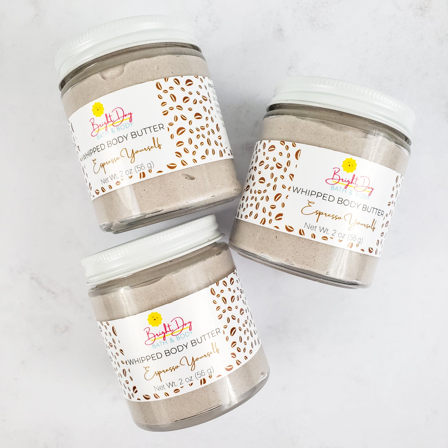 Three Espresso Yourself Body Butter Jars on a tile background