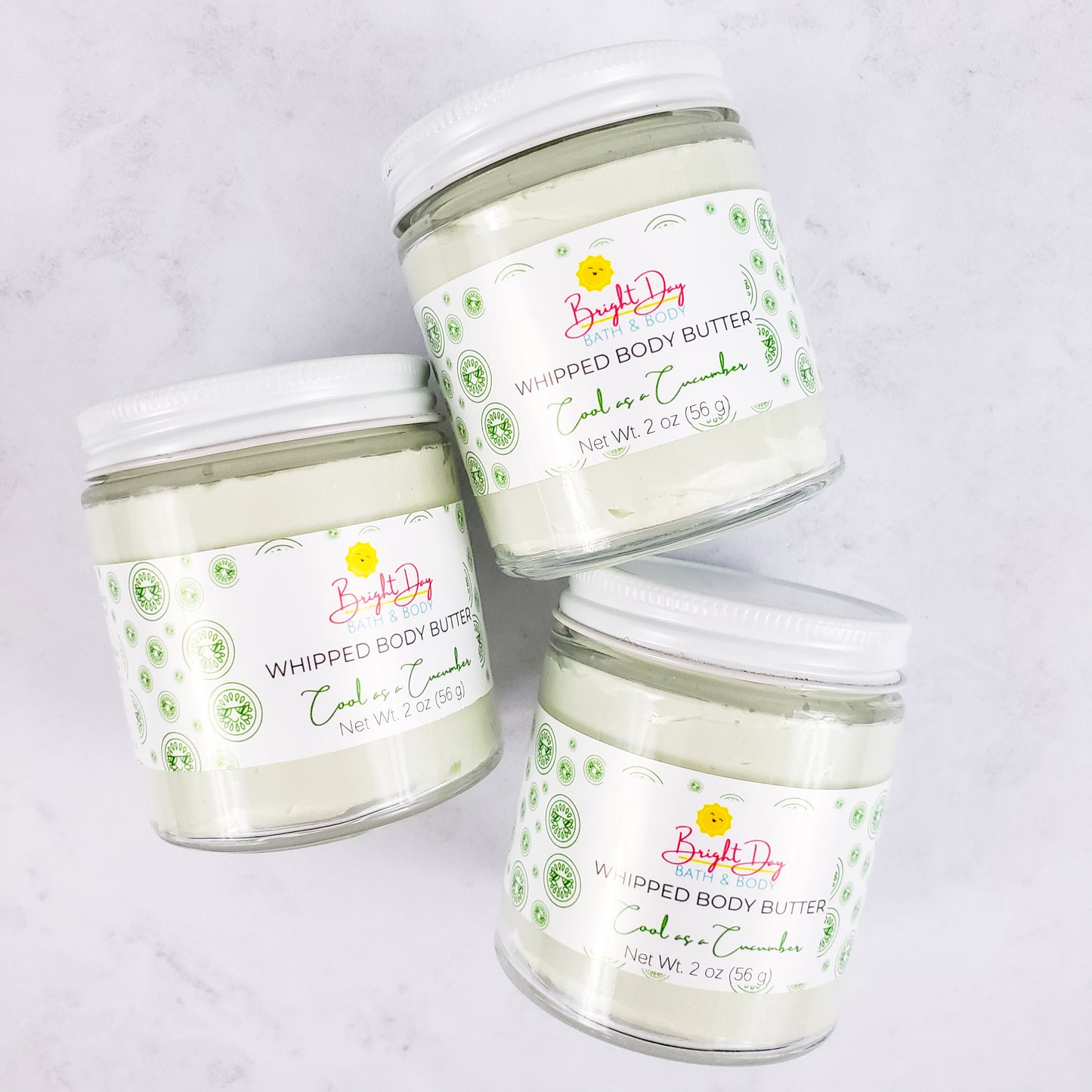 Three Cool as a Cucumber Body Butter Jars on a tile background