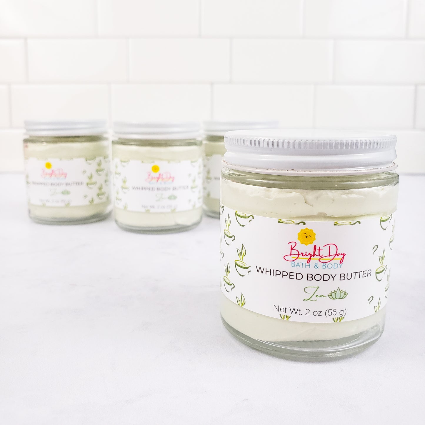 Three Zen Body Butter Jars on a tile background
