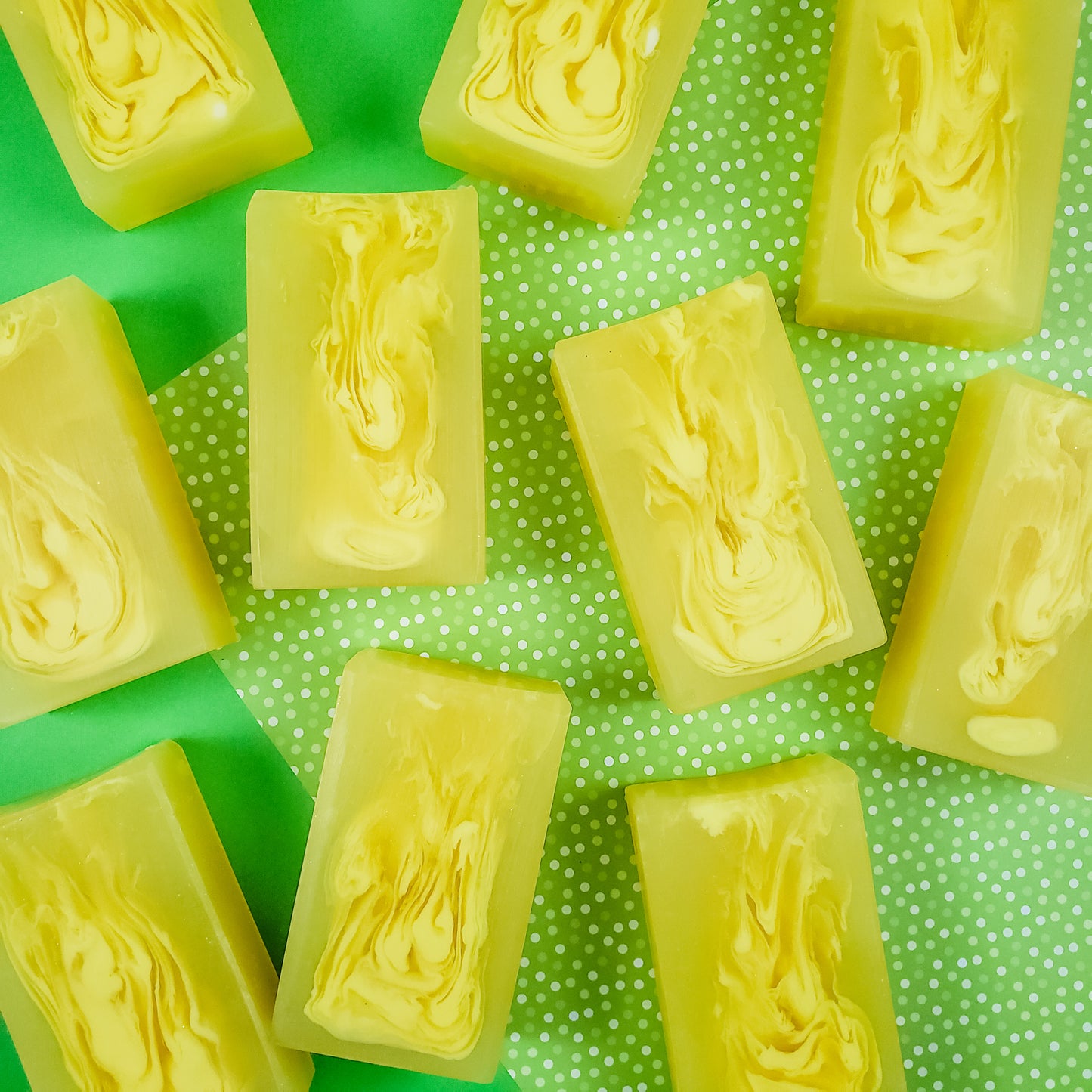 yellow bar soaps with light yellow swirls in them. on a green background