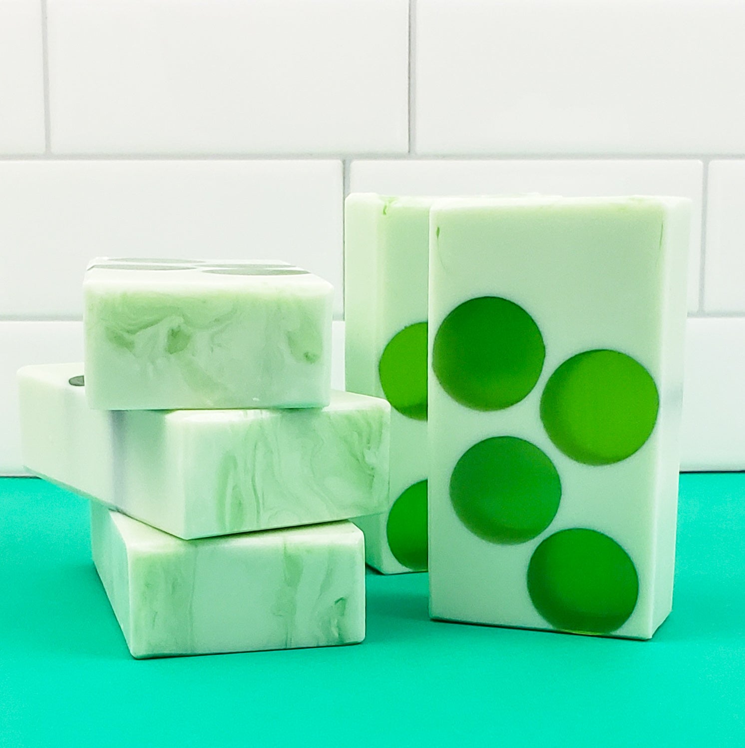 Light green soap bars with dark green translucent circles in the middle