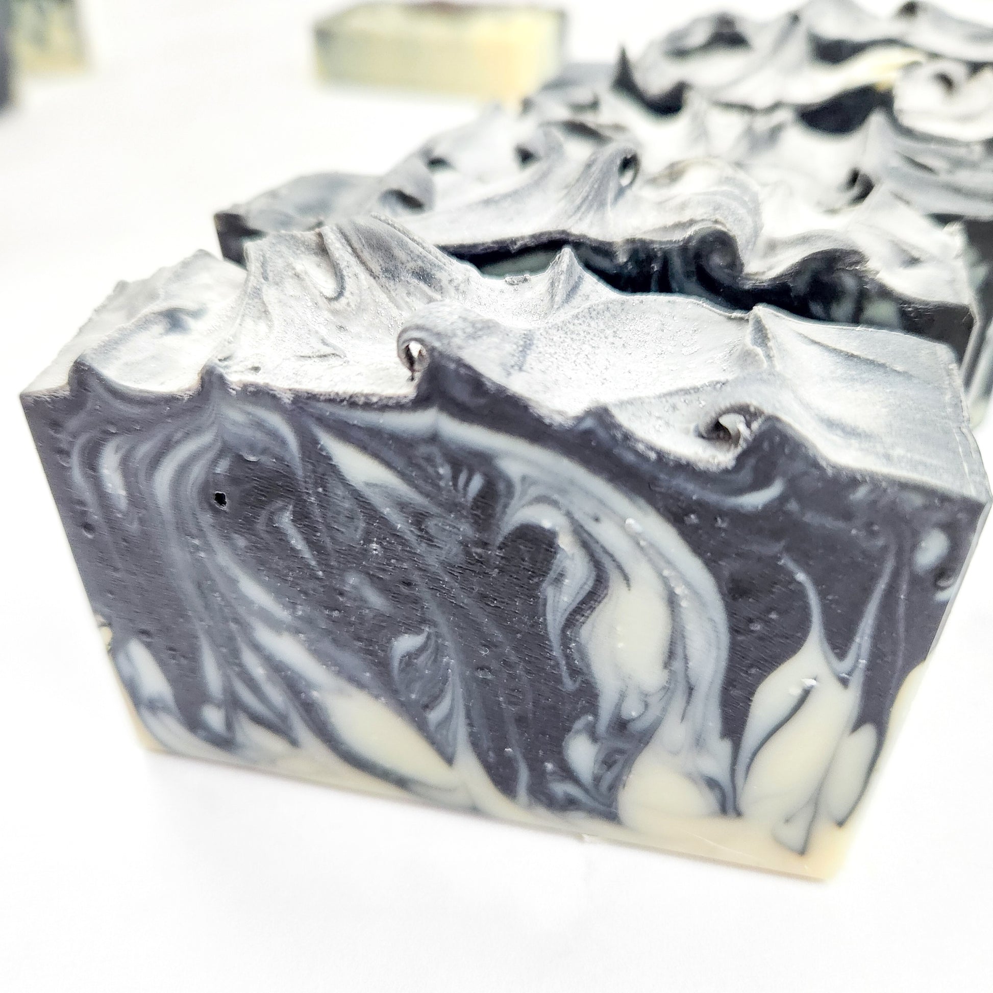 a closeup of a black and white swirled soap bar