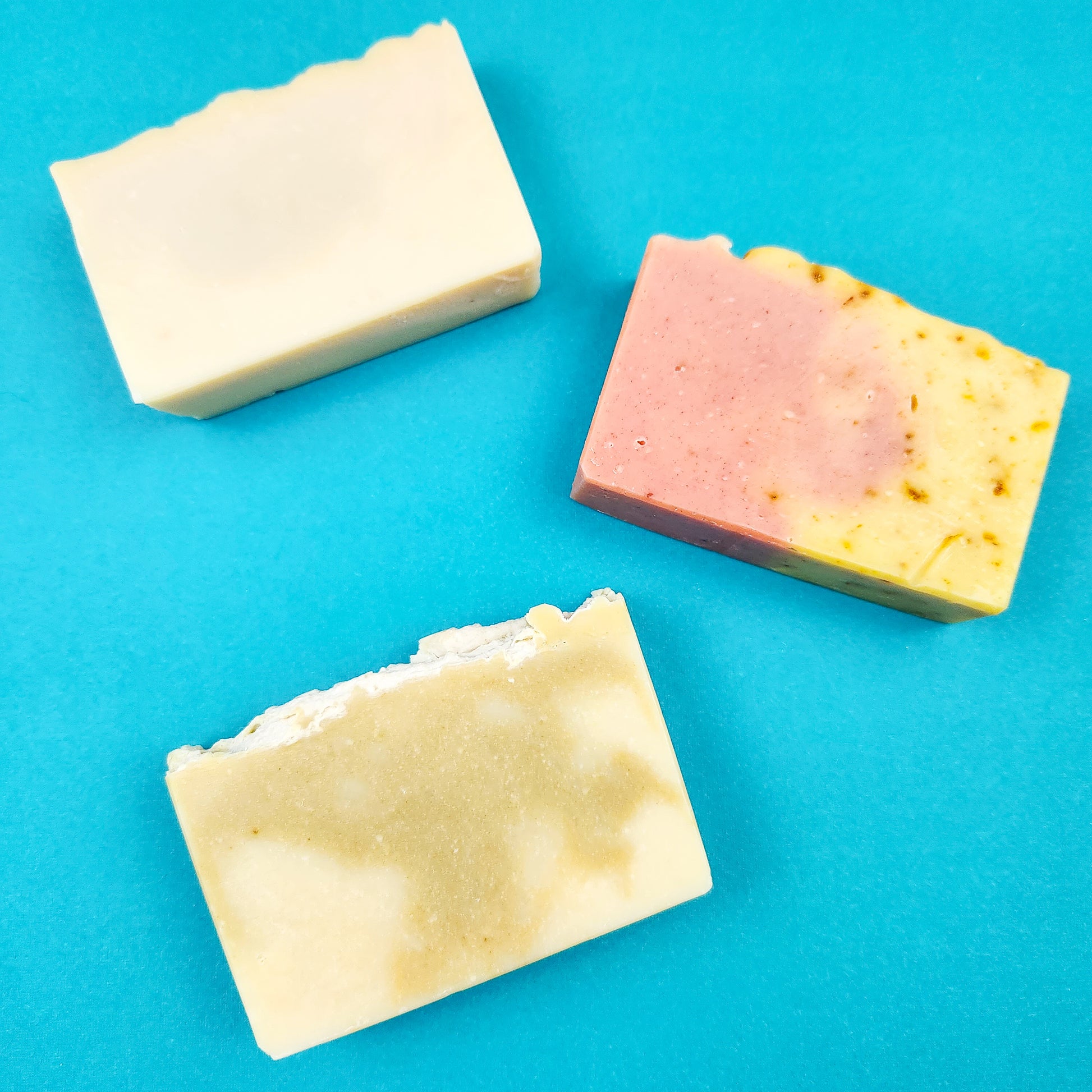 Three Bright Naturals soaps on a blue background