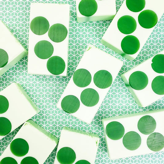 Light green soap bars with dark green translucent circles in the middle